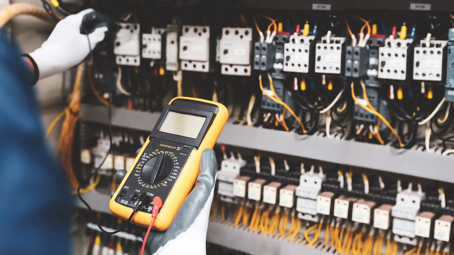 Technician using multimeter to test electrical circuits for safe event power distribution