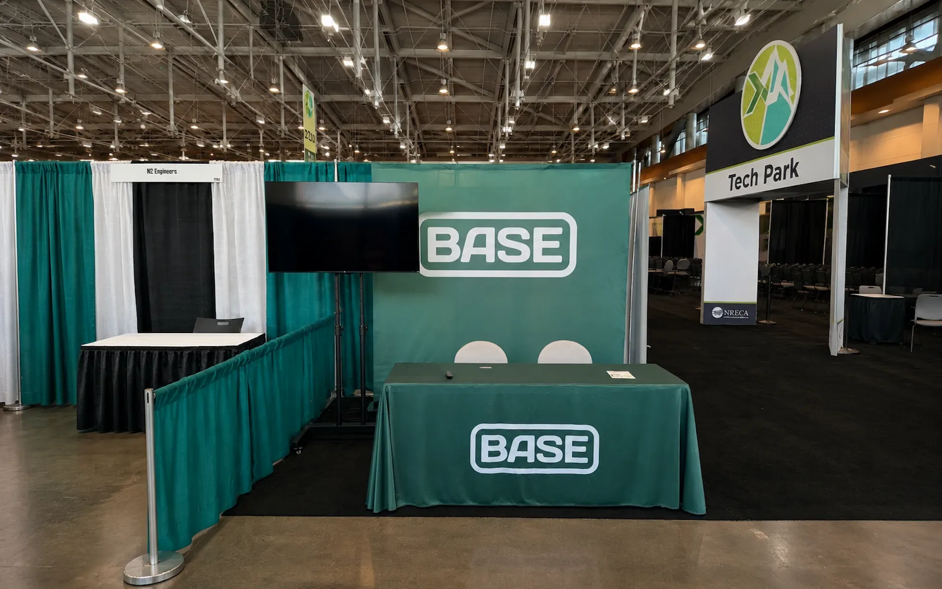 Conference booth with large digital screen displaying American flag graphic