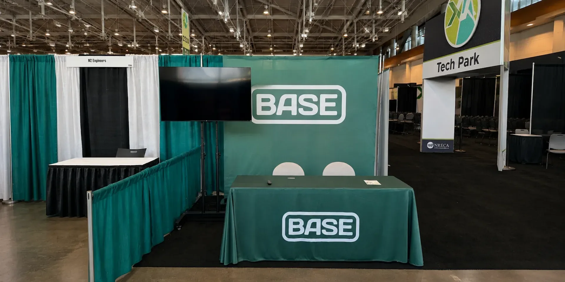 Trade show exhibitor booth with a floor-standing flat-screen TV display rental