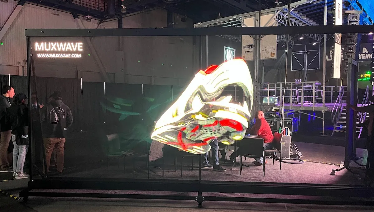 Transparent LED screen displaying content at a live event
