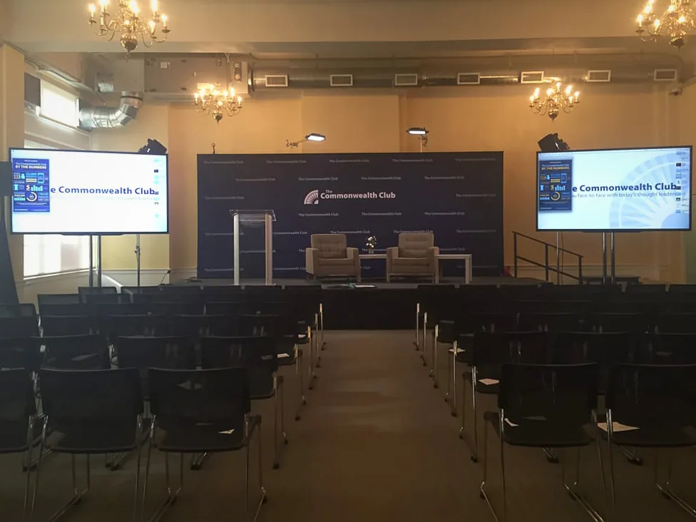 Two TV monitors on stage at a business meeting used for presentations