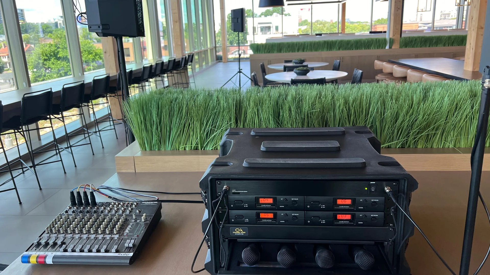 Wireless microphone rack and compact mixer equipment set up for daytime event