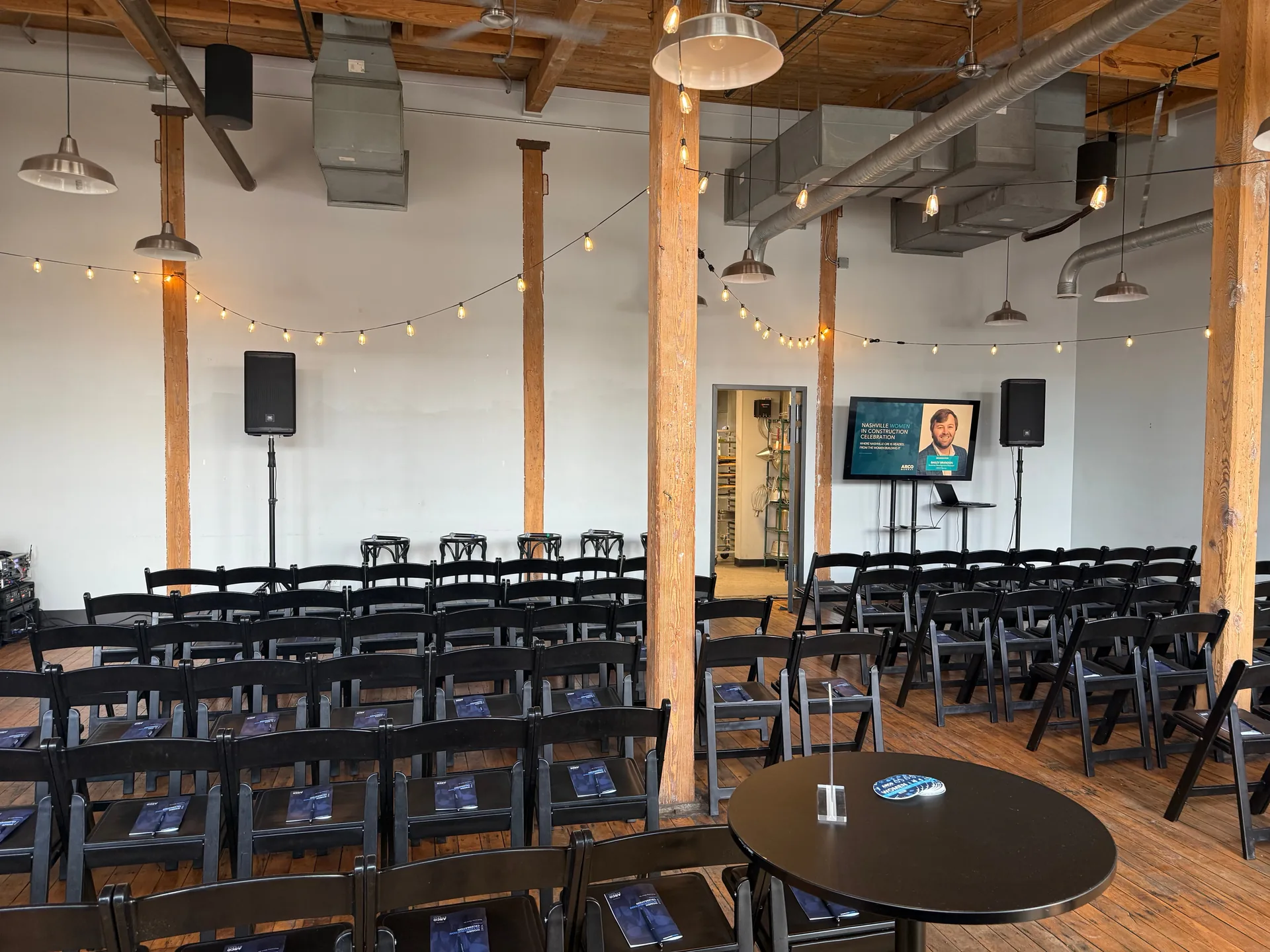 Conference room audio setup with PA speakers and audience seating for a presentation