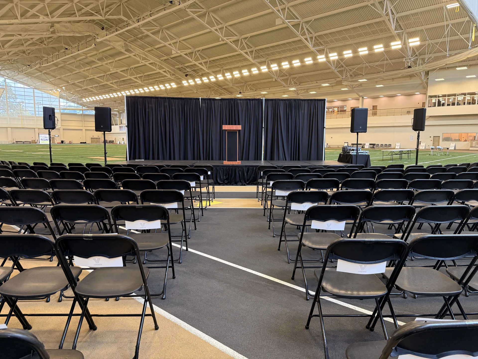 Conference stage with podium and speaker system set up for a large indoor corporate event in Nashville