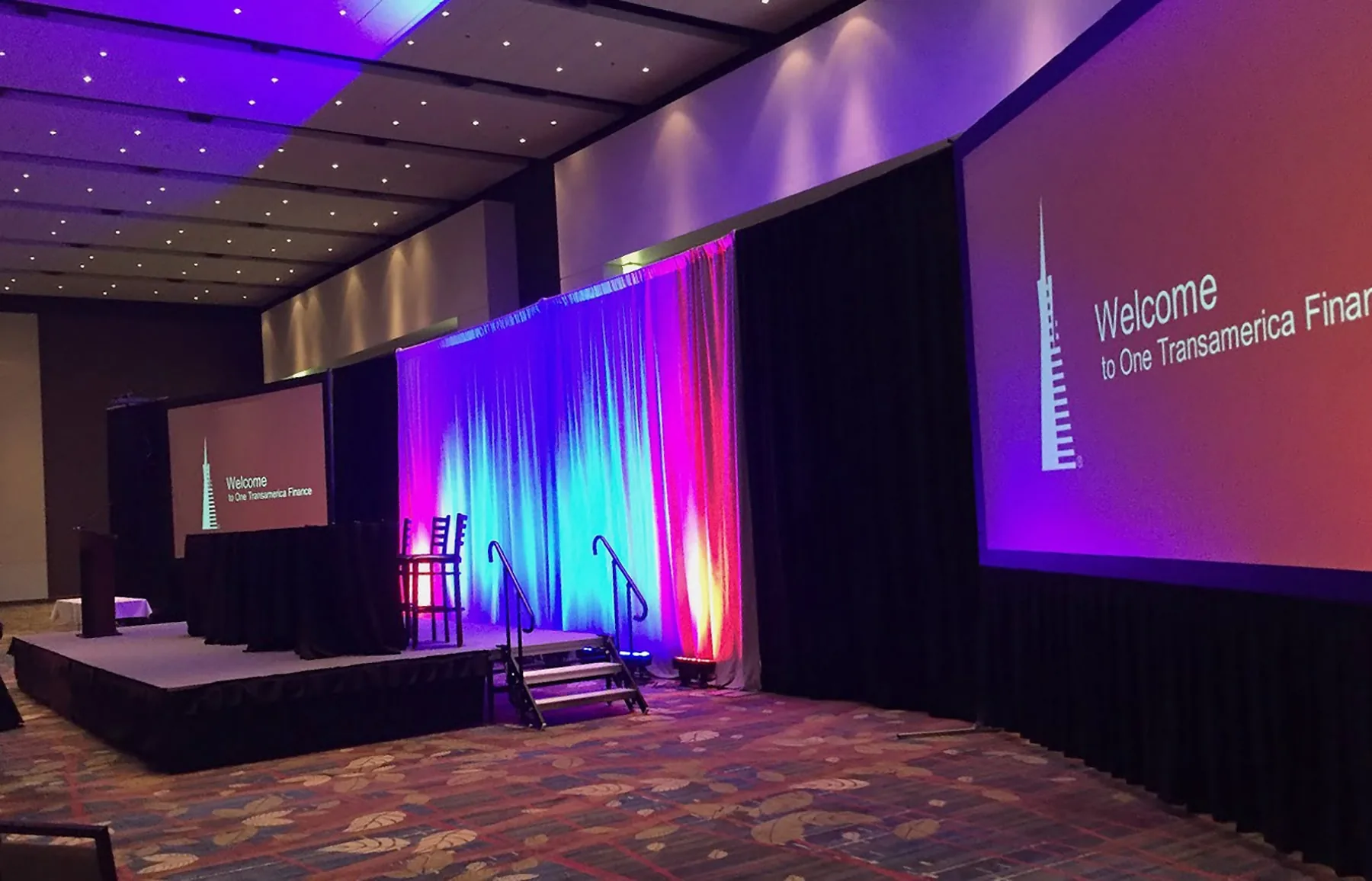 Corporate conference in Knoxville with two projection screens displaying presentation content