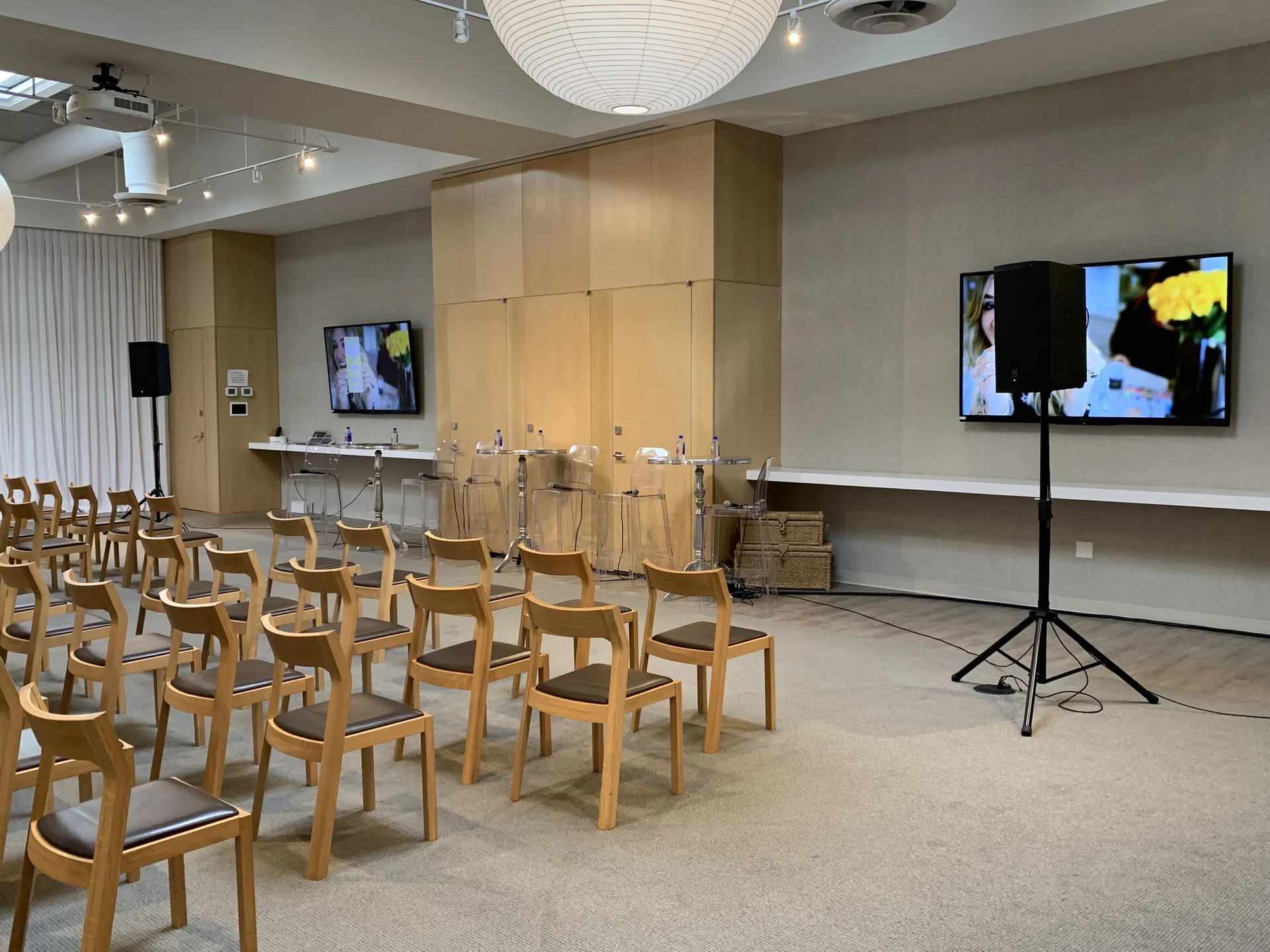 Modern conference room with rows of empty chairs and a PA audio system
