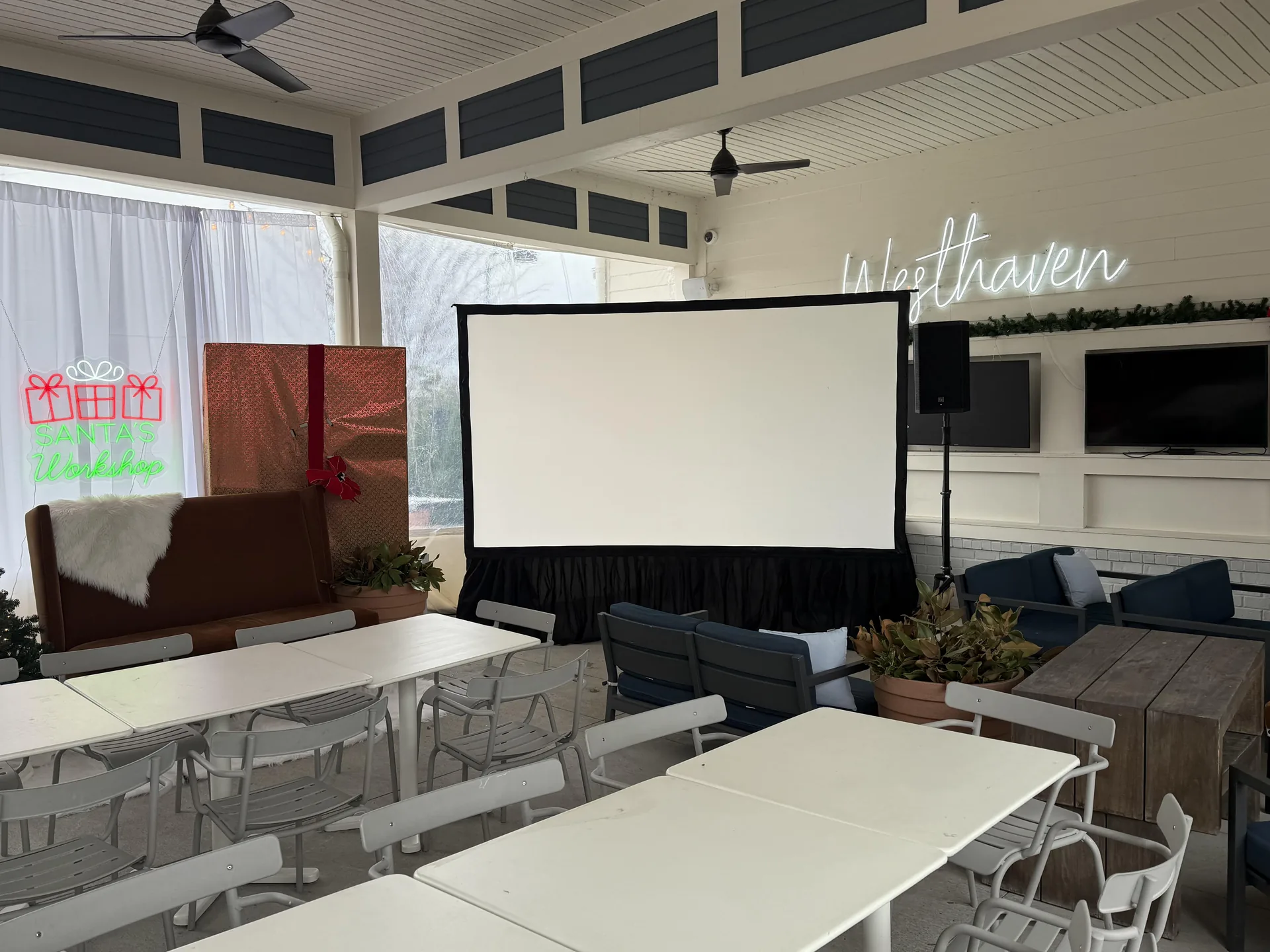 Holiday-themed event with projection screen and speaker setup at Westhaven under covered patio