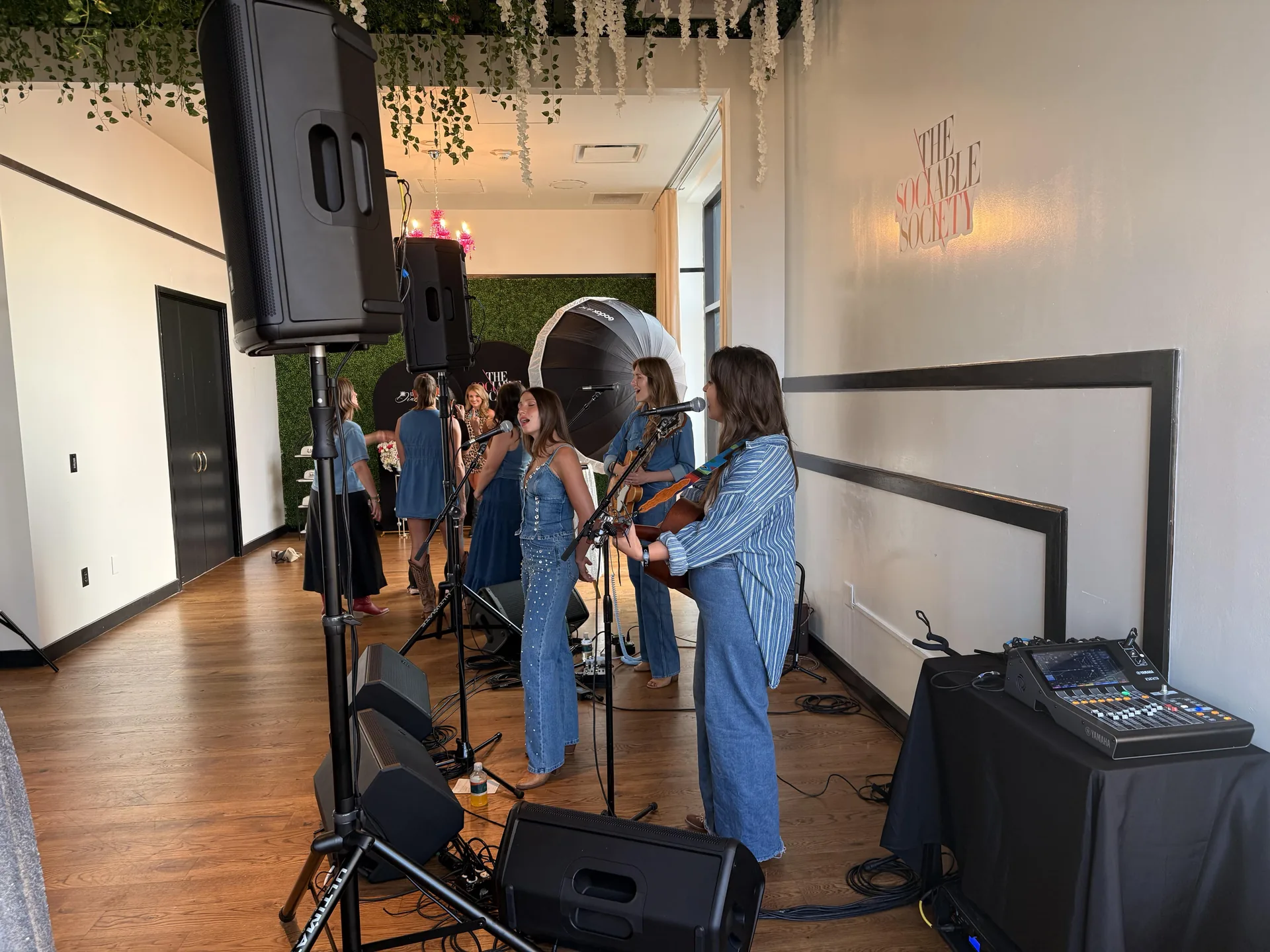 Side angle of indoor music performance setup with speakers and microphones at The Sociable Society