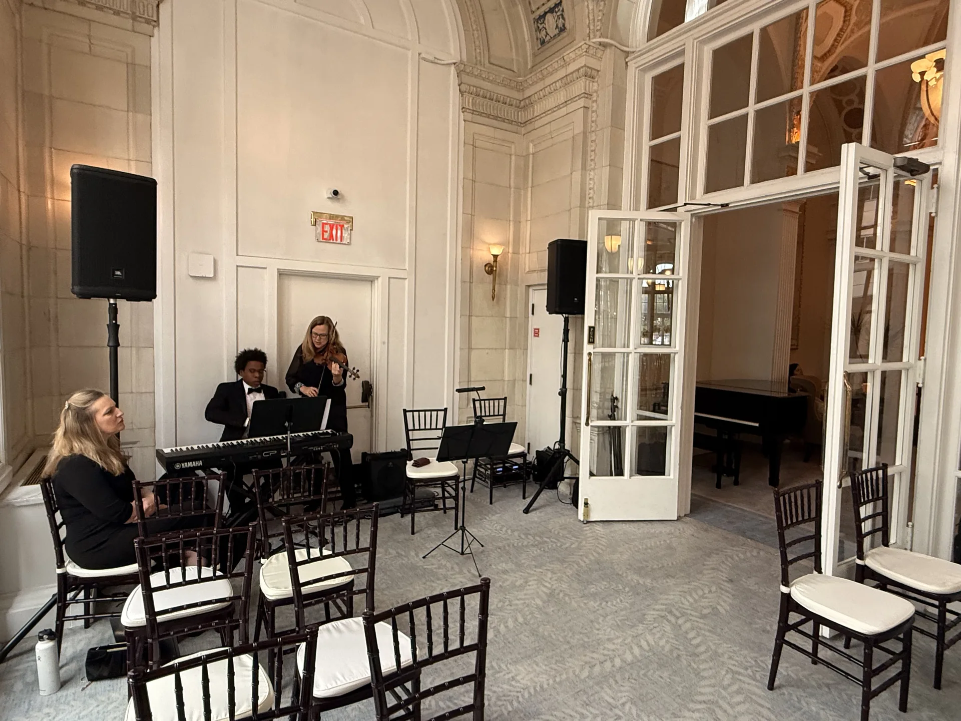 Indoor wedding string duo with microphones set up for a live performance