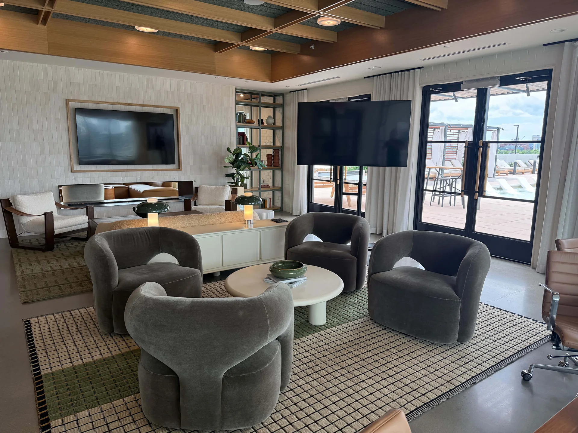 Modern lounge event space with TV display setup for casual presentation or meeting