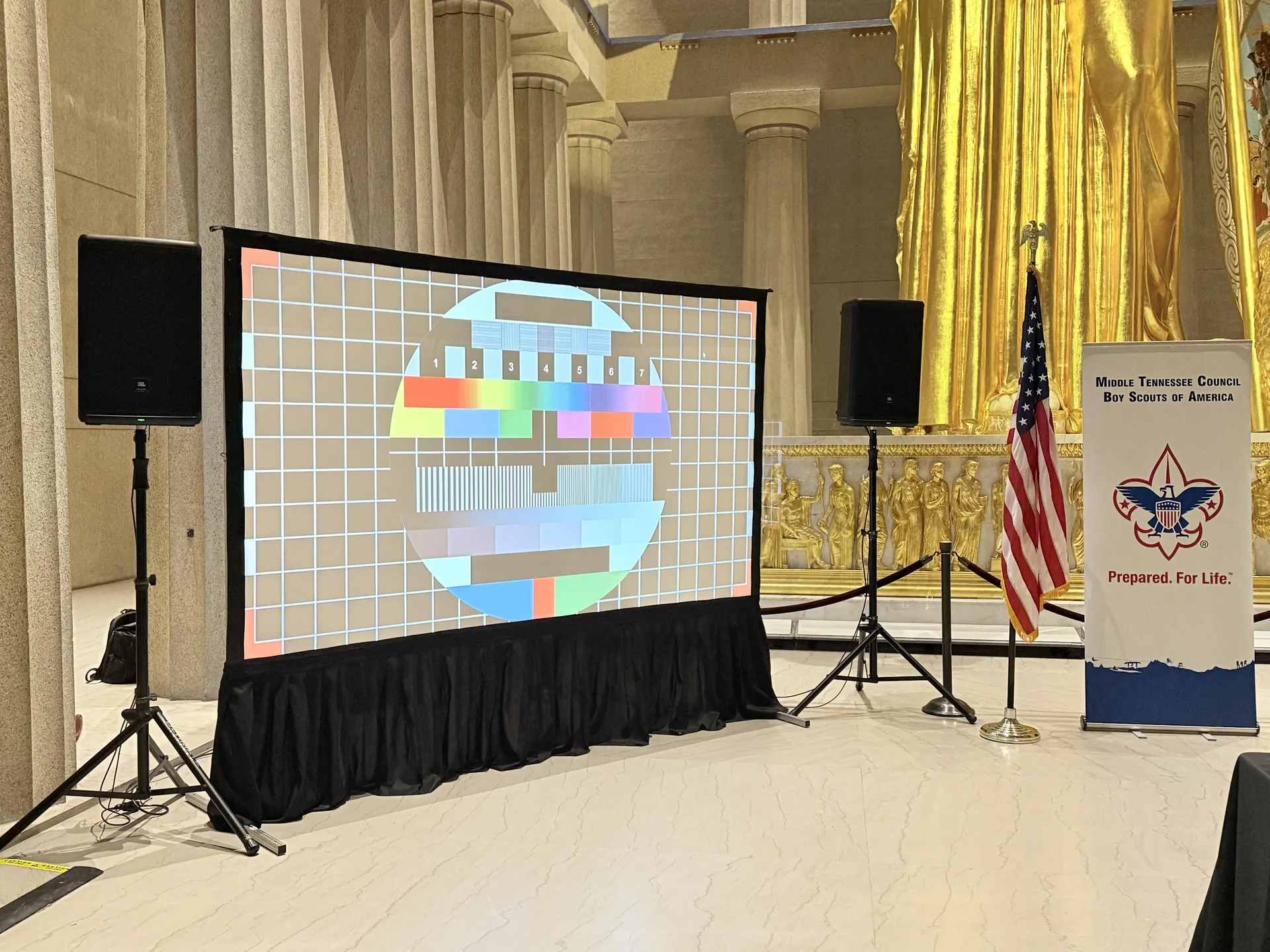 Projection screen and PA audio setup inside Nashville's Parthenon with the Athena statue and event banner