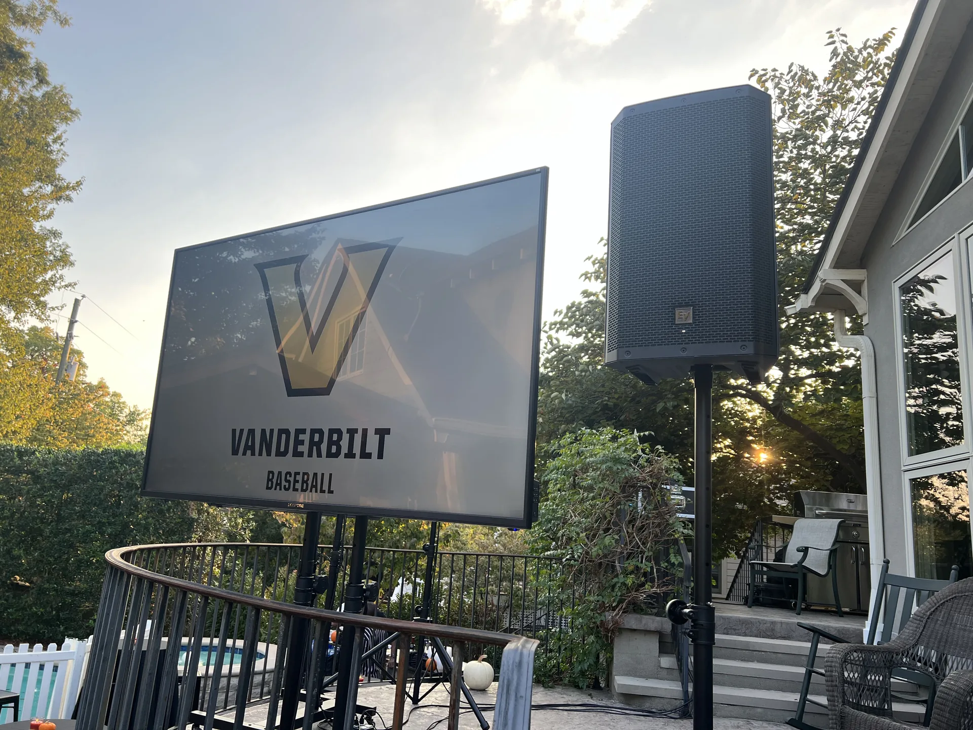 Outdoor Vanderbilt Baseball TV display with PA speaker on a residential event deck
