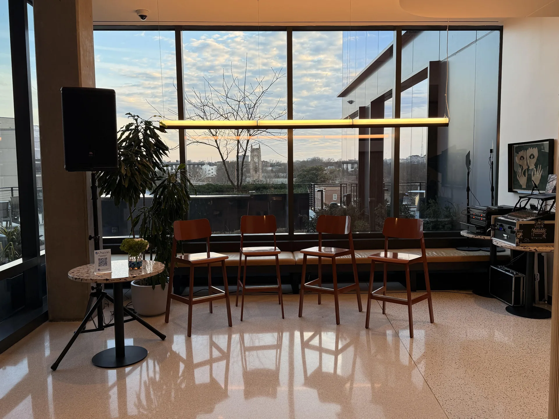 Panel discussion area with chairs, a PA speaker and audio equipment in a modern venue
