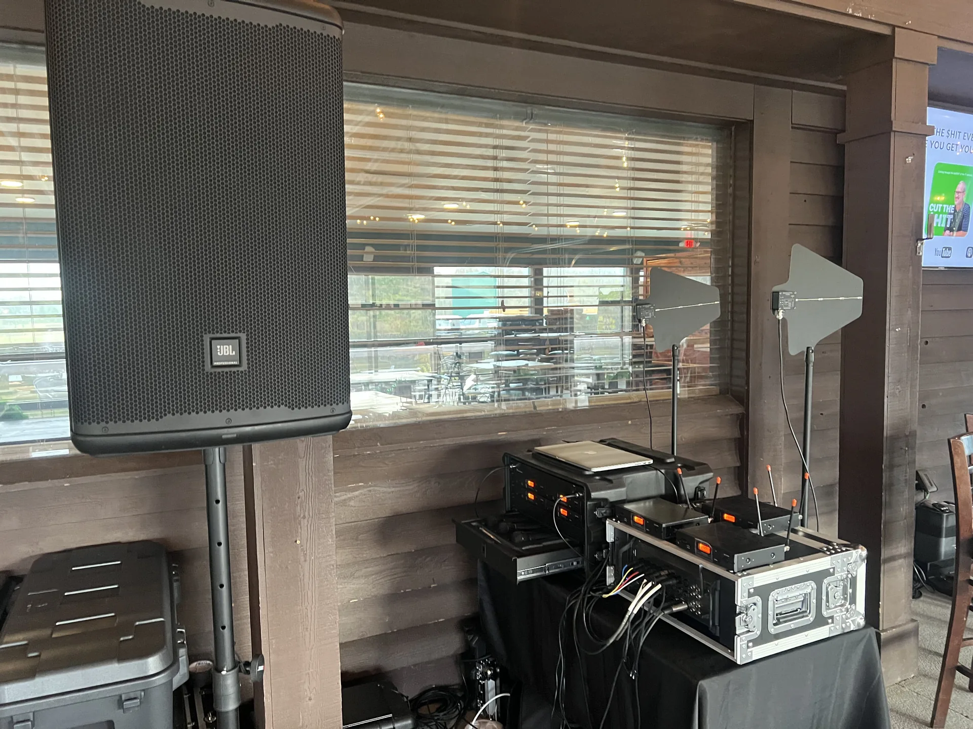 Close-up of professional audio equipment including a JBL speaker and mixers at an event space
