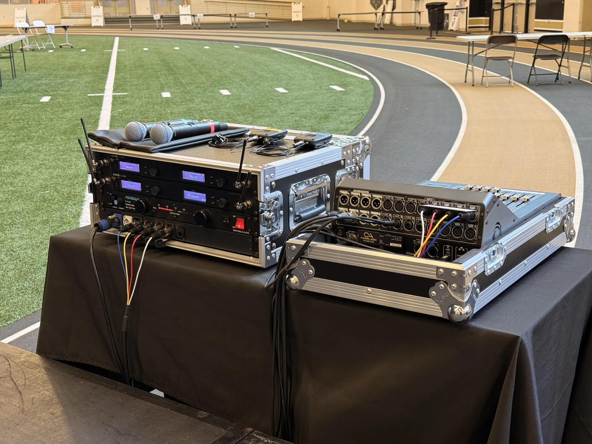 Rear view of a professional event audio rack with wireless microphone receivers and Yamaha DM3 mixer connections in Nashville