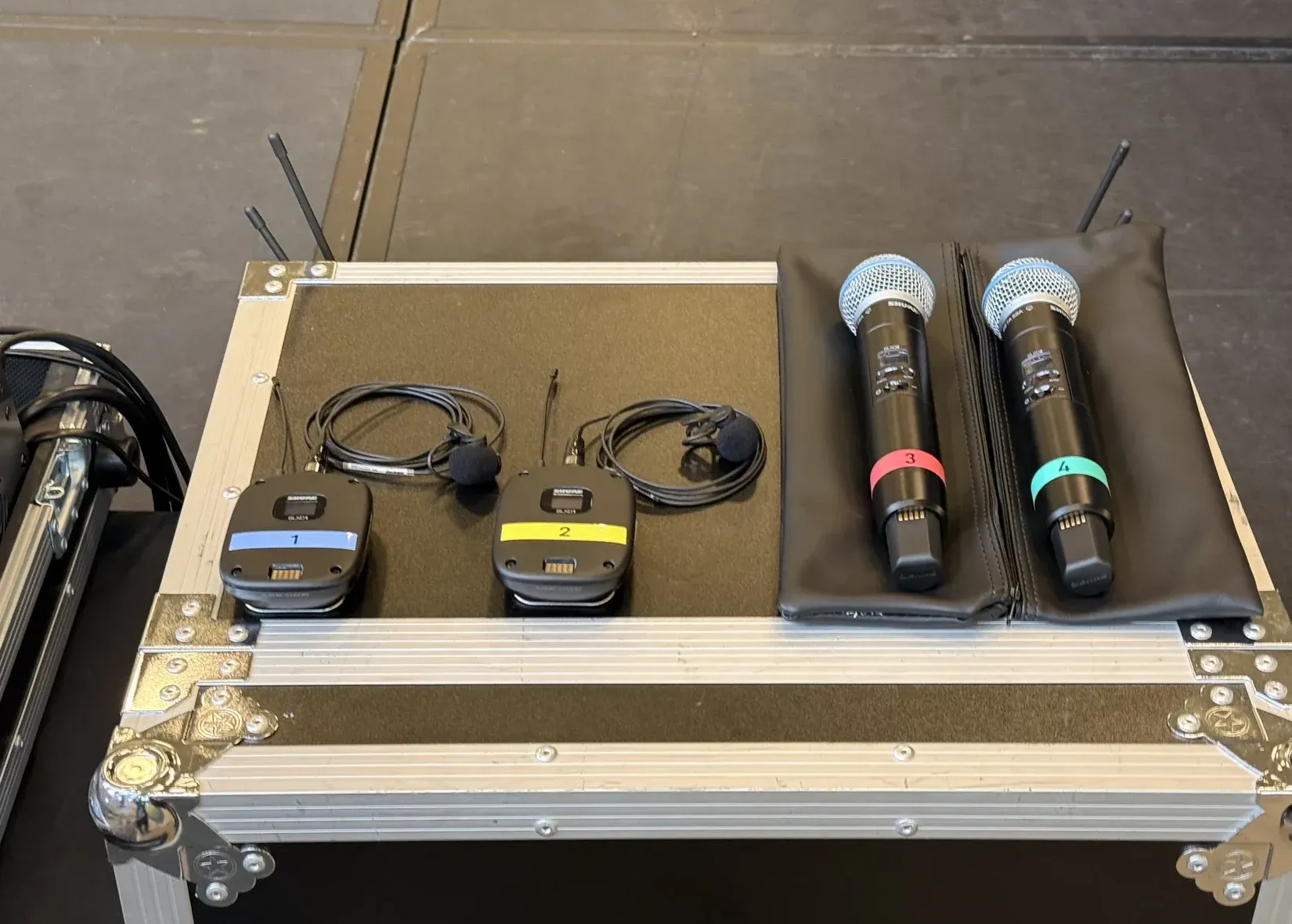 Shure wireless handheld and lavalier microphones prepared for professional corporate event audio production