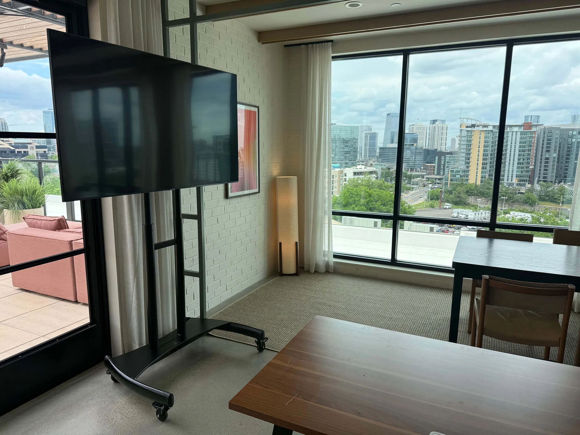 TV display setup in meeting room with city skyline view for presentation