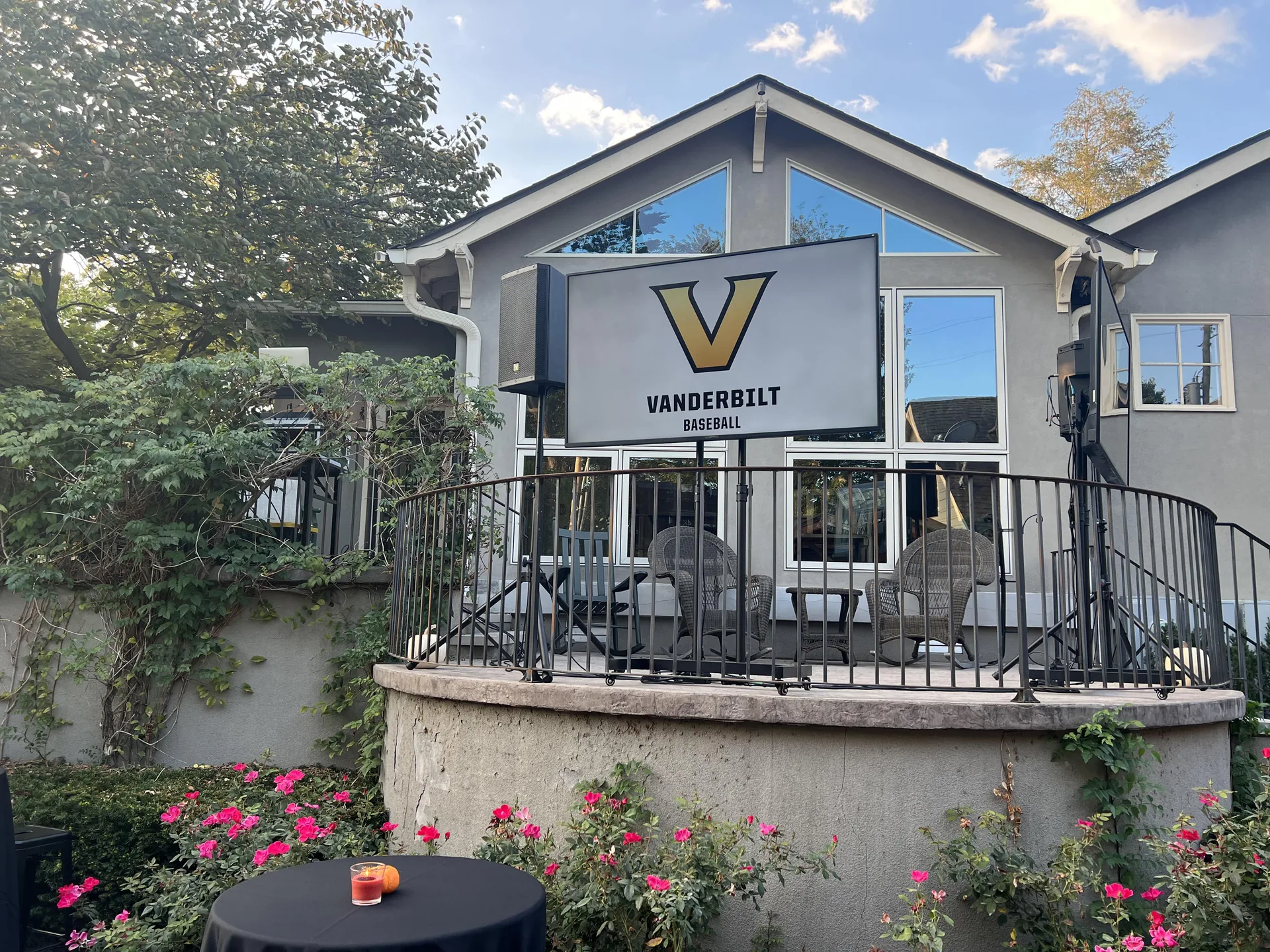 Outdoor Vanderbilt event setup with a TV display and PA audio equipment on a balcony